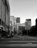 Black and white urban street cityscape with skyscrapers and city traffic