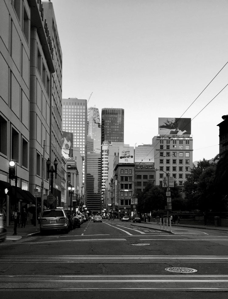 Black and white urban street cityscape with skyscrapers and city traffic
